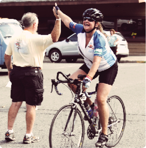 Woman on bike giving a high five