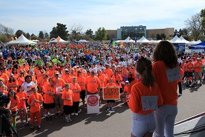 Large group of people gathered listening to a speaker